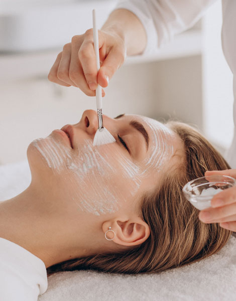 A woman receiving a facial treatment